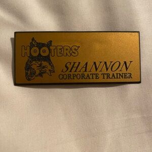 Hooters Corporate Trainer name tag “Shannon” worn by a Hooters girl